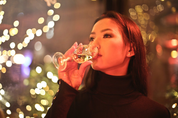 A woman drinking white wine
